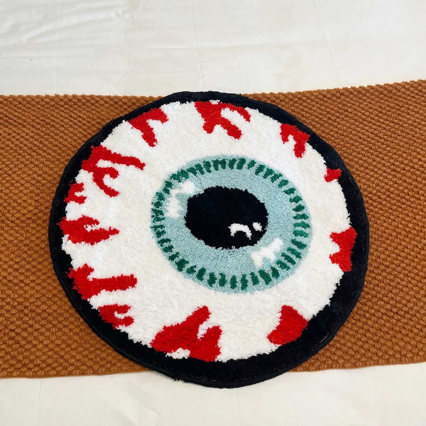 Tufted Rug Veiny Eyeball Rug Front on a Bed